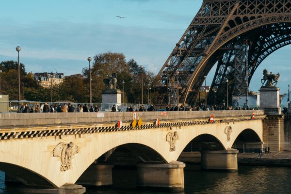 white bridge over river under white clouds during daytime