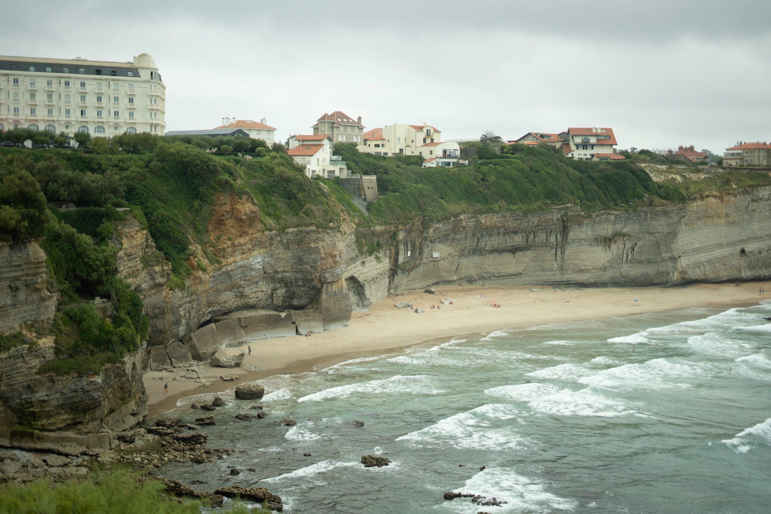 Coastal cliffs with a beach and buildings overlooking