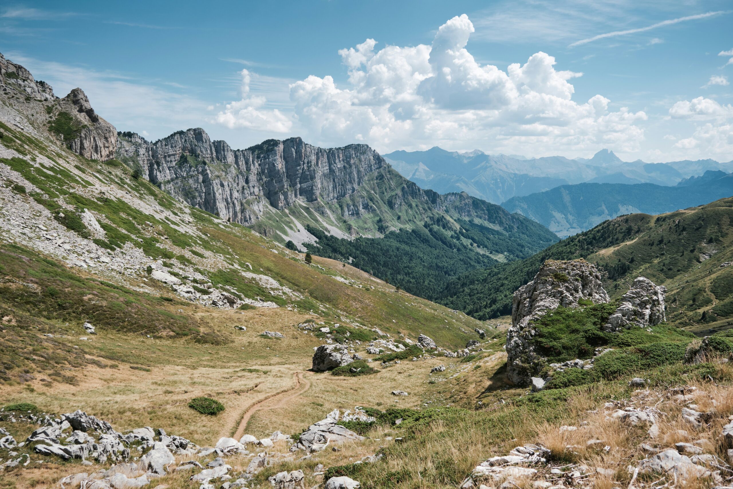 Mountains and valley under a bright, blue sky.