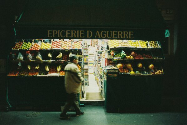 woman in white long sleeve shirt and black pants standing in front of black and white