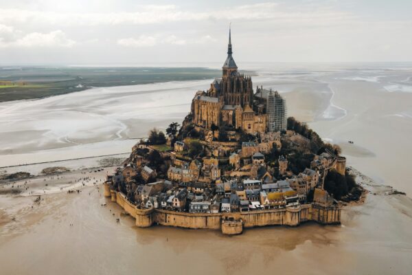 an aerial view of a castle on a beach
