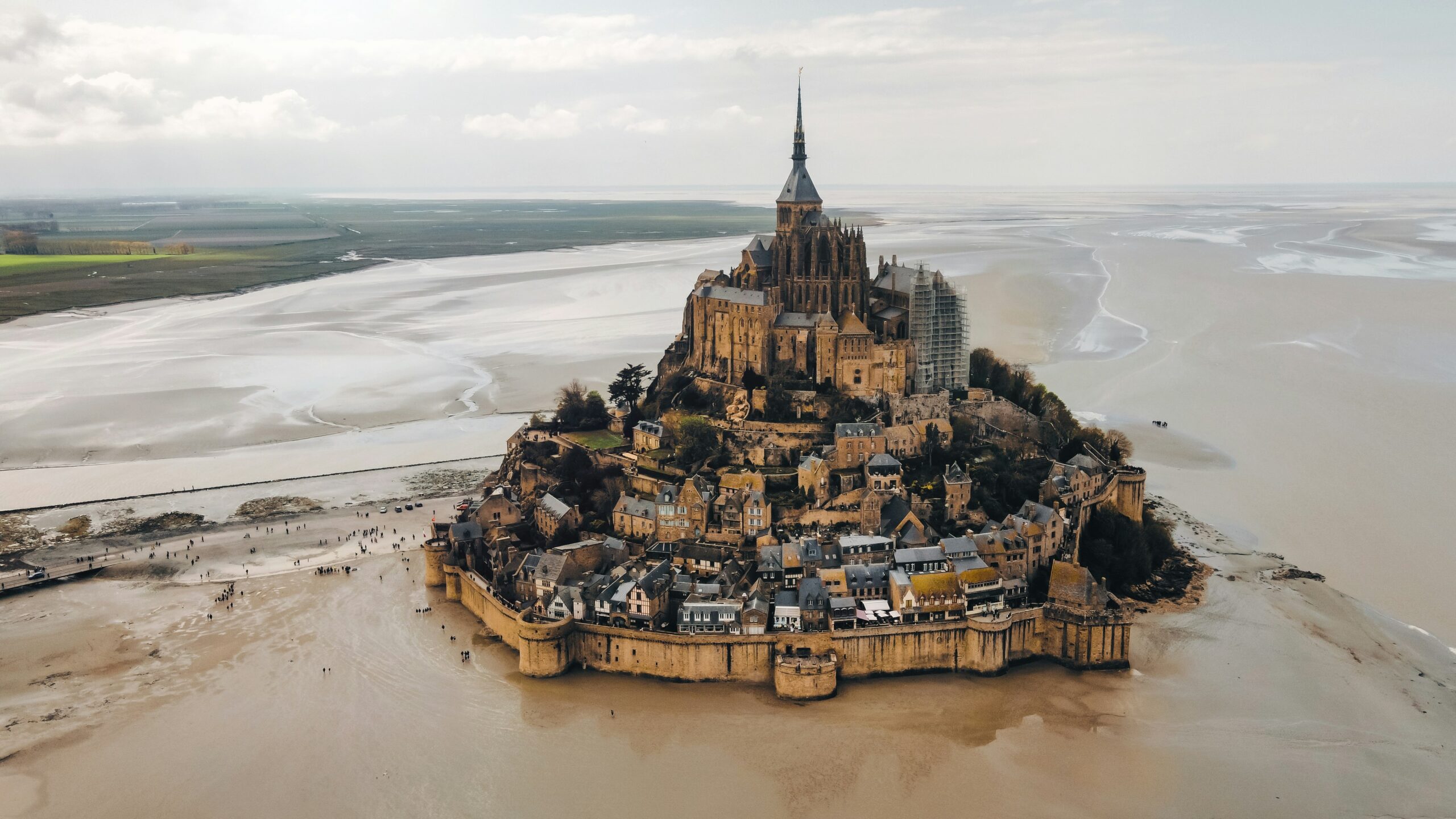 an aerial view of a castle on a beach