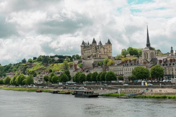 a castle on a hill by a river