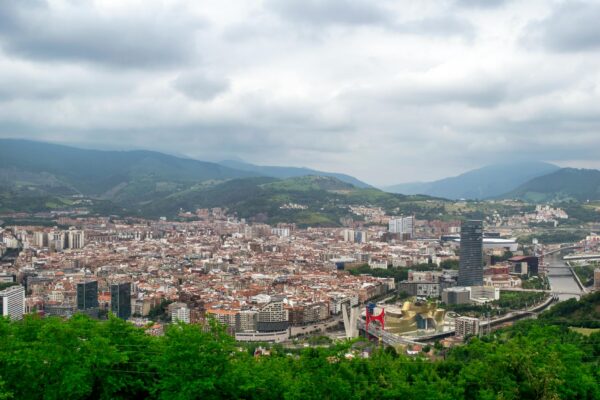 Aerial view of Bilbao, Spain featuring the Guggenheim Museum and surrounding urban landscape.