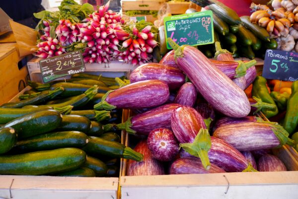 green and purple vegetables on brown wooden crate