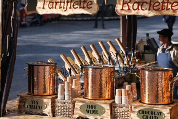 a man standing in front of a table filled with pots and pans