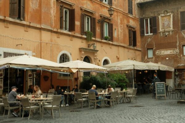 What is the tipping etiquette in Rome restaurants and cafes?