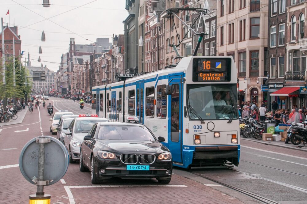 How do I register with the municipality in Amsterdam?