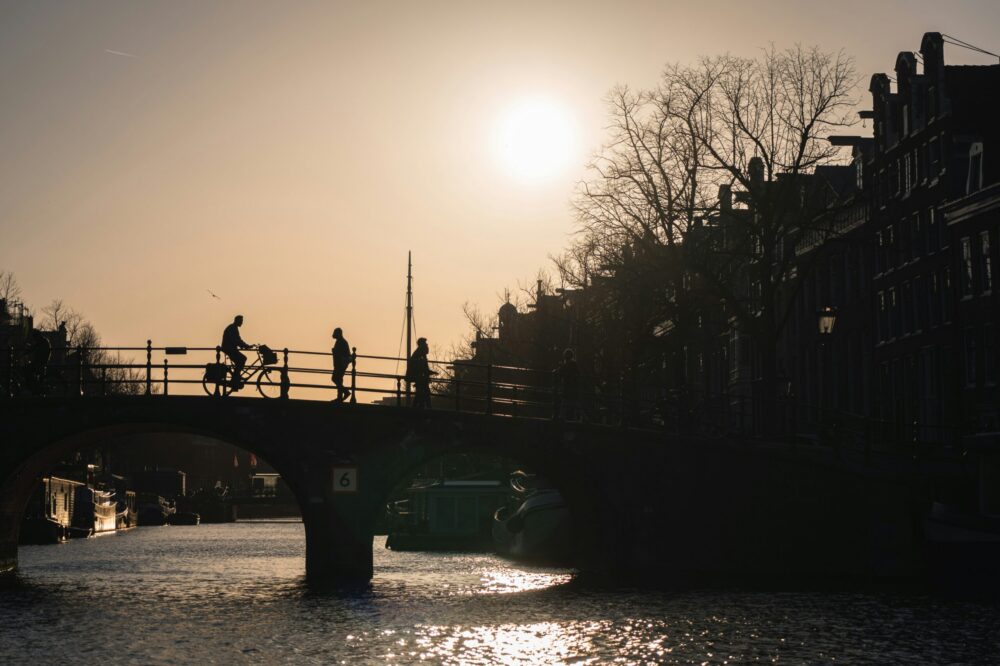 Which budget hotels in Amsterdam have airport shuttle service?